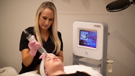 Skin care A woman receiving skin rejuvenation treatment at Vibrant Skin Bar by Jalair Whitman